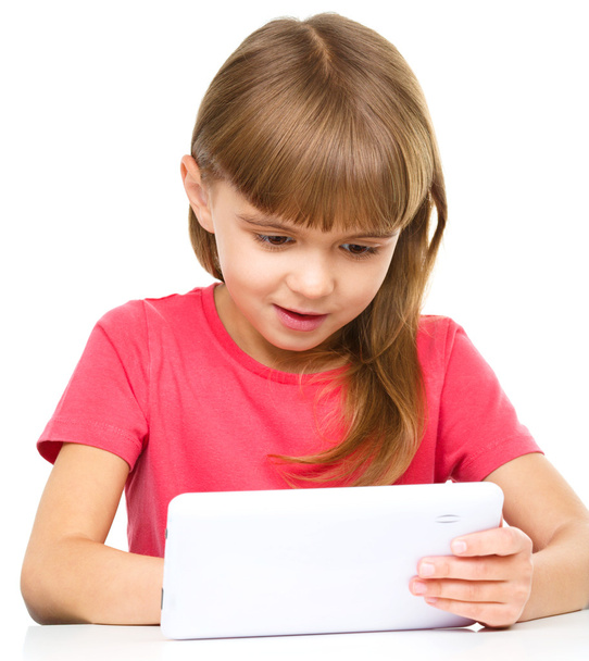 Young girl is using tablet - Фото, зображення