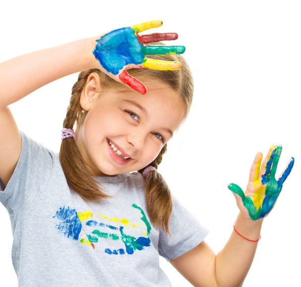 Portrait of a cute girl playing with paints - Photo, Image