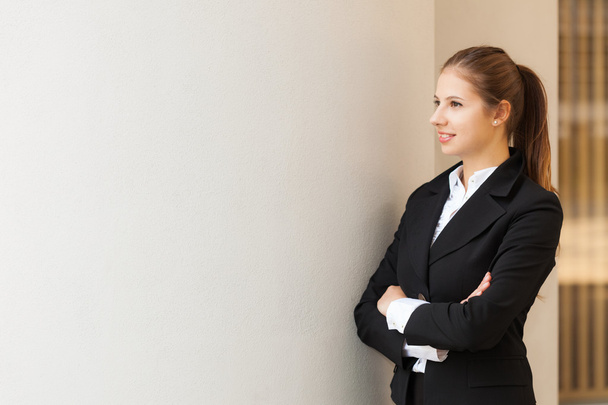 Businesswoman posing in front of wall - Photo, image