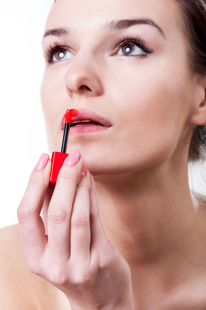 Woman painting her lips with red lipstick - Zdjęcie, obraz