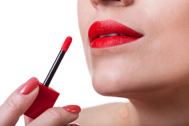 Painting lips with red lipstick - Photo, Image