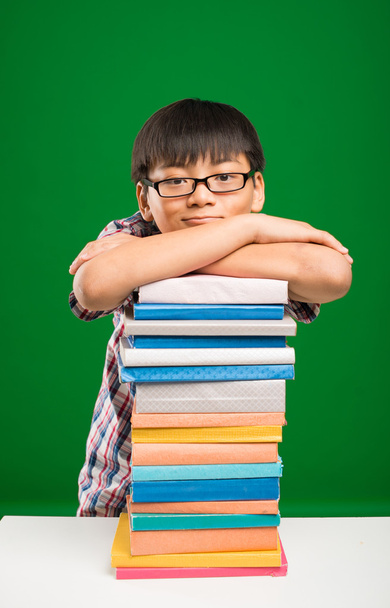 Schoolboy leaning on books - Photo, Image