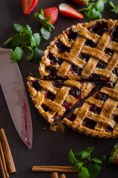 homemade apple pie with berries and mint on a wooden background - Φωτογραφία, εικόνα