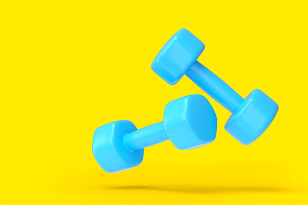 Pair of rubber blue dumbbells isolated on yellow background - Foto, immagini