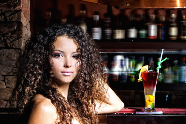 Brunette girl  with coctail in bar - Fotó, kép