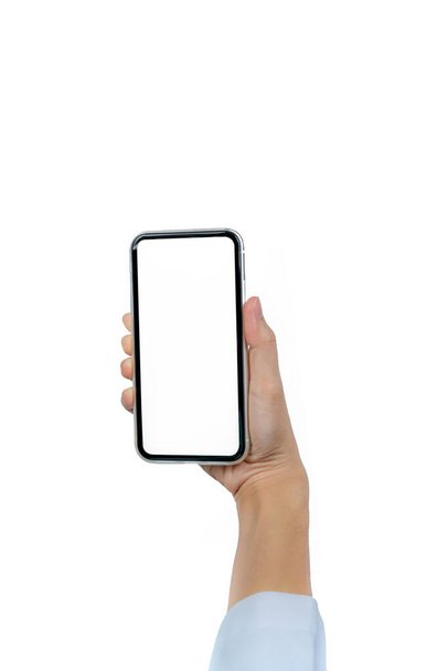 Woman's hand holding smartphone. Closeup doctor hand holding smartphone with blank screen display isolated on white background. Mobile phone with blank screen. Online marketing. Telemedicine concept. - 写真・画像