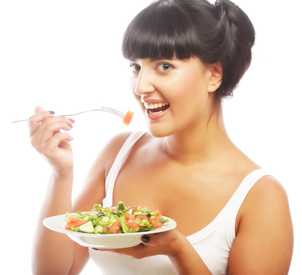 Young happy woman eating salad. - Foto, afbeelding