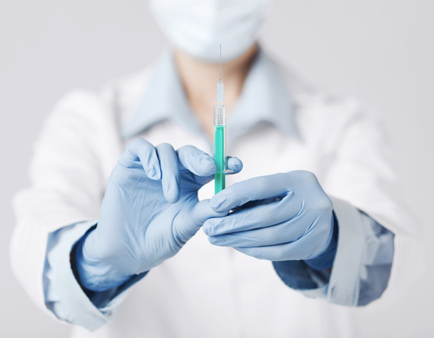 female doctor holding syringe with injection - 写真・画像