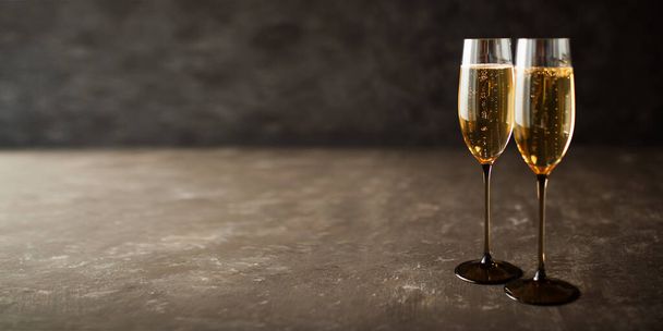Two glasses with champagne on old gray stone plate - Foto, afbeelding