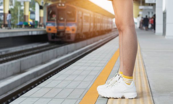 Woman standing and waiting in train station. Travel concept. - Photo, Image