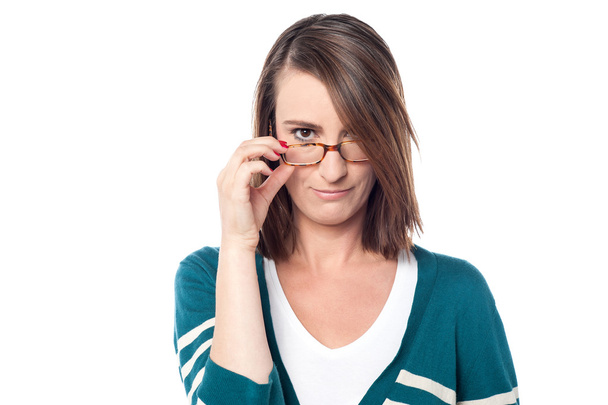 Woman adjusting her eyeglasses - Fotó, kép