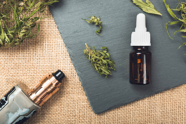 Vape pen and medical marijuana hemp bud. CBD and THC oil vaping products - Photo, image