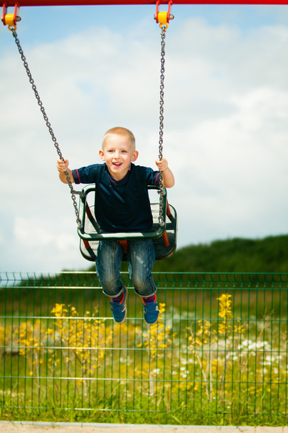 Child having fun on a swing outdoor - Photo, image