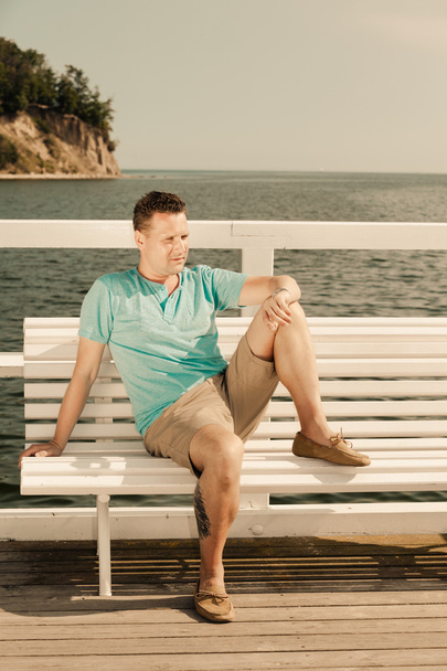 Handsome man on bench outdoor - Photo, Image