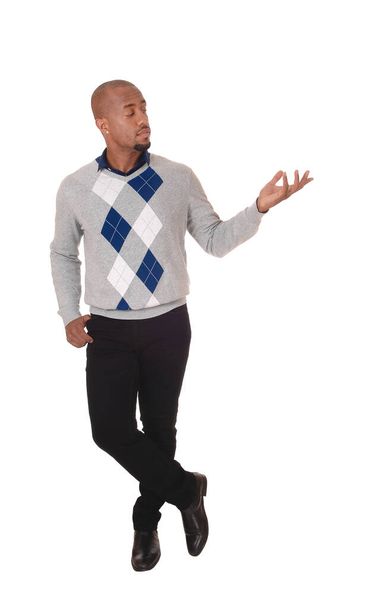 A full body image of an African American man standing in a sweater and.black pants, holding his hand out, isolated for white background. - Foto, Imagem