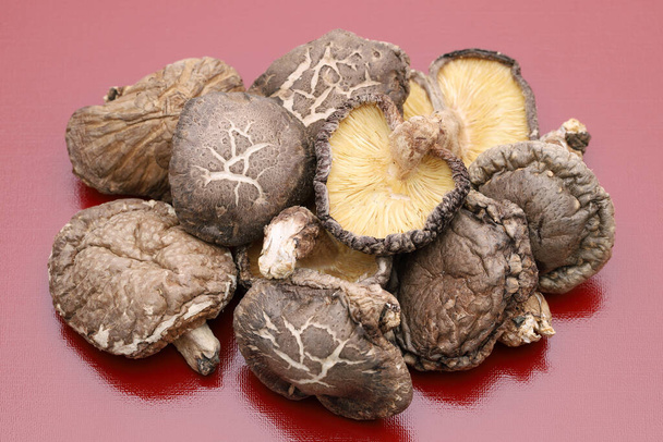 Japanese dried shiitake mushrooms on red background - Zdjęcie, obraz