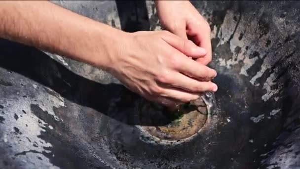Cool your hands on a hot summer day in a drinking water fountain. - Footage, Video