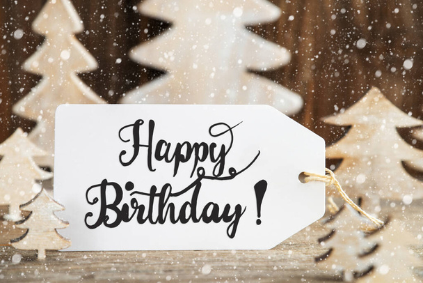 Label With English Text Happy Birthday. White Wooden Christmas Tree As Decoration. Brown Wooden Background With Snow - Φωτογραφία, εικόνα