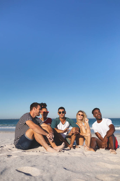 Front view of group of happy diverse friends having fun together on the beach - Foto, Imagen