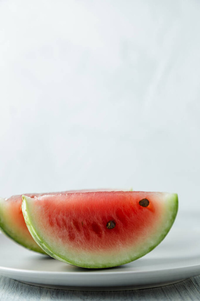 Sliced watermelon, honey watermelon on wooden table background. Very healthy, natural, vegetarian food. - 写真・画像