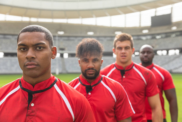 Portrait of handsome diverse male rugby players standing together while looking at the camera in stadium - Foto, Imagen