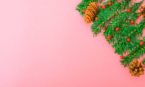 Happy New Year and Christmas day, top view flat lay composition decoration tree fir branch on pink background with copy space for your text - Fotó, kép