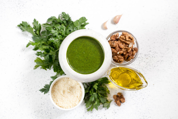 Homemade parsley pesto sauce and ingredients. Vegan healthy food - Fotografie, Obrázek