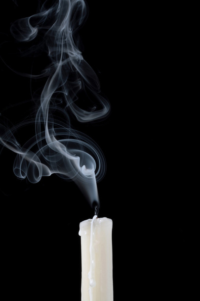 Smoke and extinct candle on a black background - Photo, Image