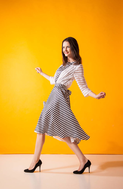 Smiling woman in beautiful dress posing at studio - Zdjęcie, obraz
