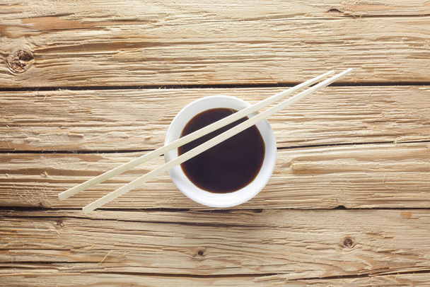 wooden chopsticks on a black background - Photo, Image