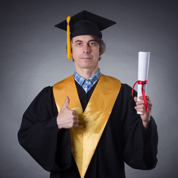 Man in an academic cap  with diploma - Photo, Image