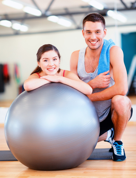 two smiling people with fitness ball - Foto, afbeelding