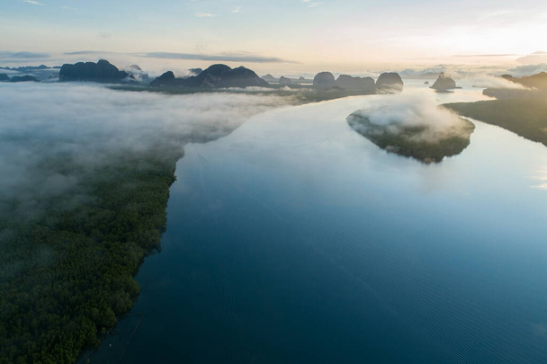 Aerial view drone shot of beautiful ocean against sky in the morning fog mist sunrise drone is flying over sea and mangrove forest Landscape High angle view Dynamic aerial shot Amazing nature view - Photo, Image
