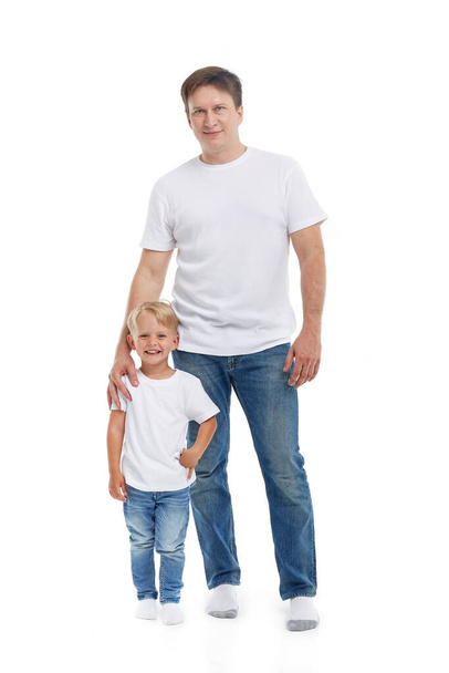 Friendly family. Young man with child stands isolated on a white background. Happy parent. Father with son. Concept of people and family - 写真・画像