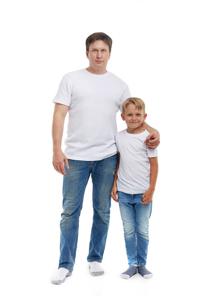 Friendly family. Young man with child stands isolated on a white background. Happy parent. Father with son. Concept of people and family - Fotó, kép