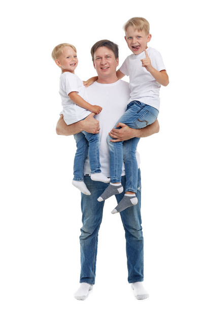 Friendly family. Young man with two children stand isolated on a white background. Happy parent. Father with two sons. Concept of people and family - Photo, Image