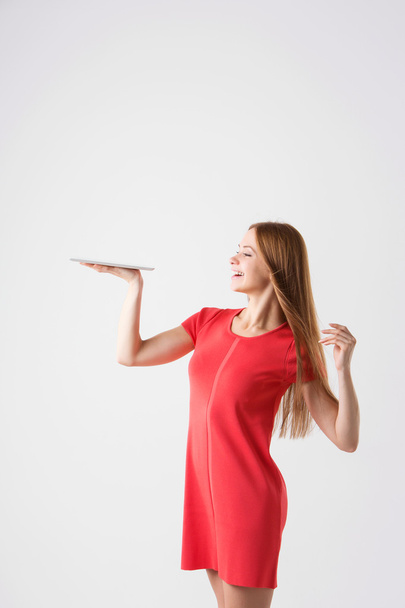 winner woman excited holding tablet pc isolated on white background.  - Valokuva, kuva