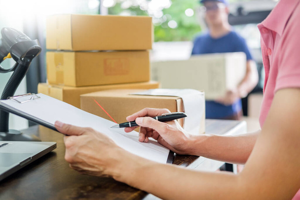 Courier hands Business woman work at home office checking parcel package box by keying machine track tools before ship and documents data. - Zdjęcie, obraz
