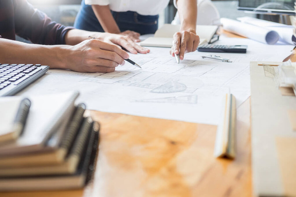professional architects working on blueprint discussing construction plans, engineer building, business co-working teamwork concept - 写真・画像