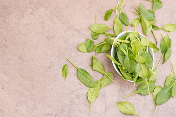 Spinach on a brown textured background, empty space for text - Фото, изображение