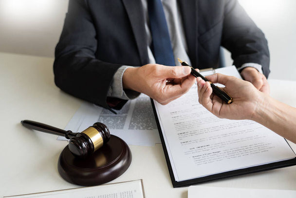 business people and lawyers discussing contract papers sitting at the table. Concepts of law, advice, legal services, legal and judgment concept - Foto, imagen