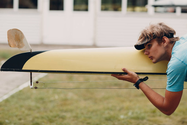 Sportsman single scull man rower prepare to competition with boat - Photo, Image
