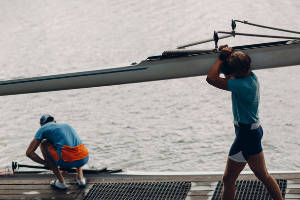 Sportsman single scull man rower prepare to competition with boat - Photo, Image