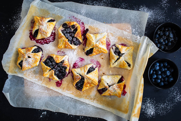 Blueberry cakes on baking paper - Foto, imagen