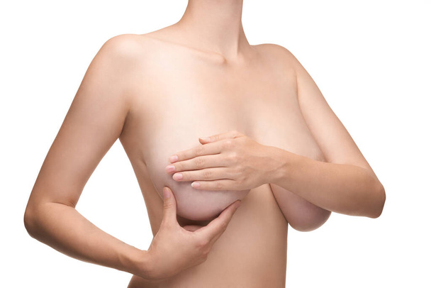 young woman feels her breasts as a precaution. - Foto, Bild