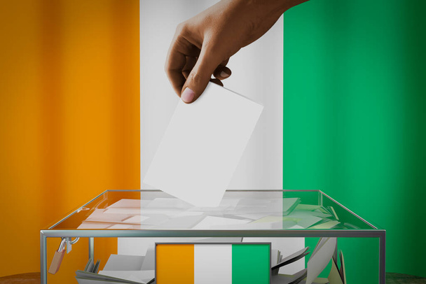 投票、選挙のコンセプト- - 3Dイラスト-コートdアイボワールフラグ、投票カードを箱に落とす手 - 写真・画像