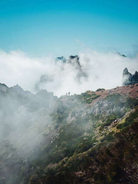 A vertical shot of the mountain peak with clouds and blue sky in the background. Madeira. - Foto, immagini