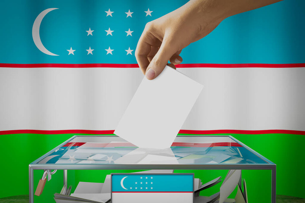 Bandera de Uzbekistán, mano dejando caer la tarjeta de votación en una caja - votación, concepto electoral - Ilustración 3D - Foto, Imagen