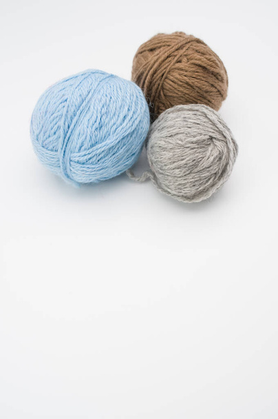 A vertical shot of colorful yarns on a white background - Photo, Image