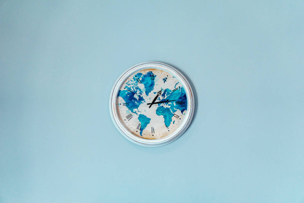 A closeup shot of a clock on the blue wall - Foto, afbeelding